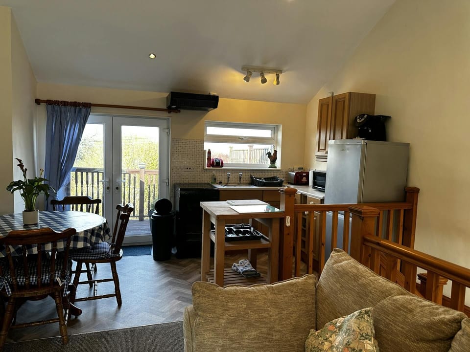 Kitchen/dining area; fitted kitchen with dining table and chairs, sofa