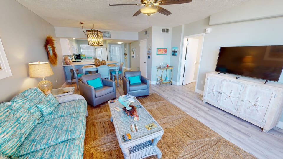 Open living, dining and kitchen. Smart TV in living room.