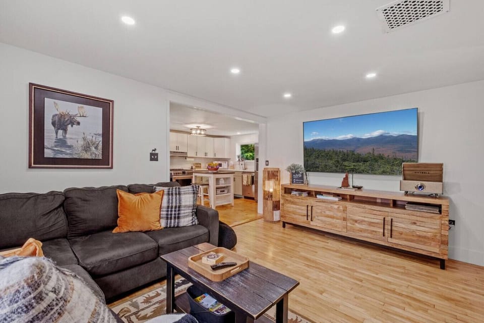 Spacious living room with comfortable seating, smart TV, and open flow to the kitchen—perfect for family time