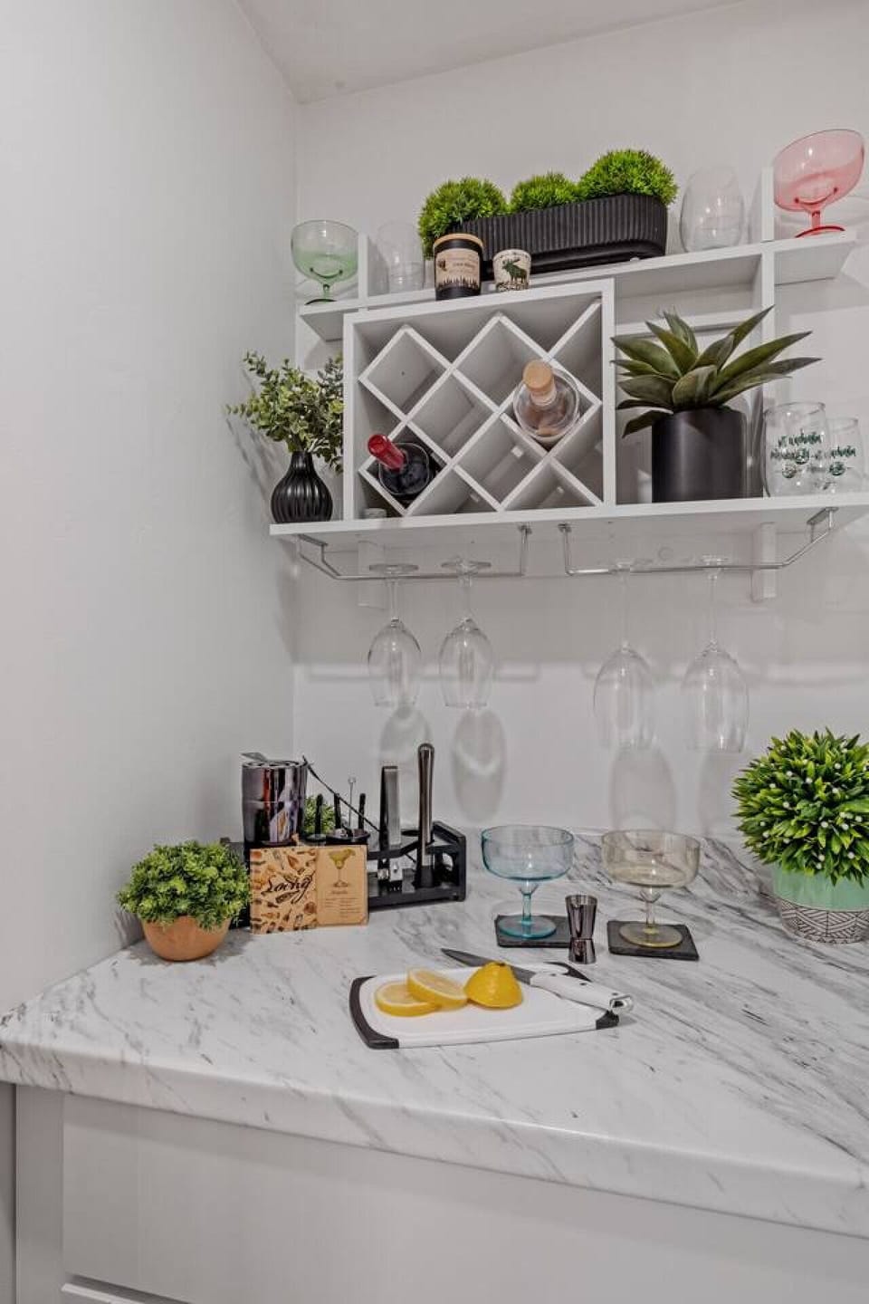 Dedicated beverage station with wine storage, glassware, and prep space