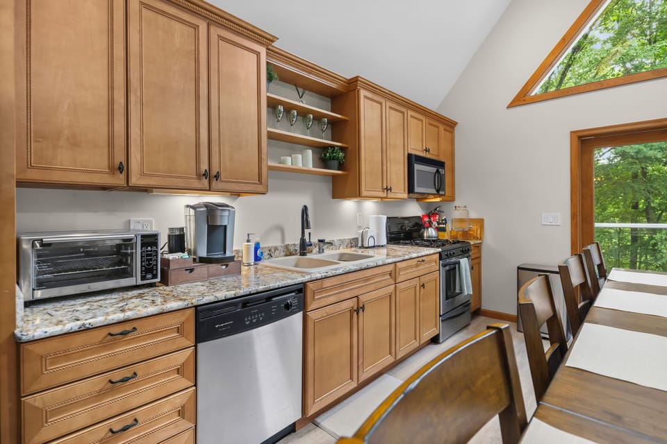 Bright kitchen with granite counters, coffee bar, double sink, dining space for 8 people