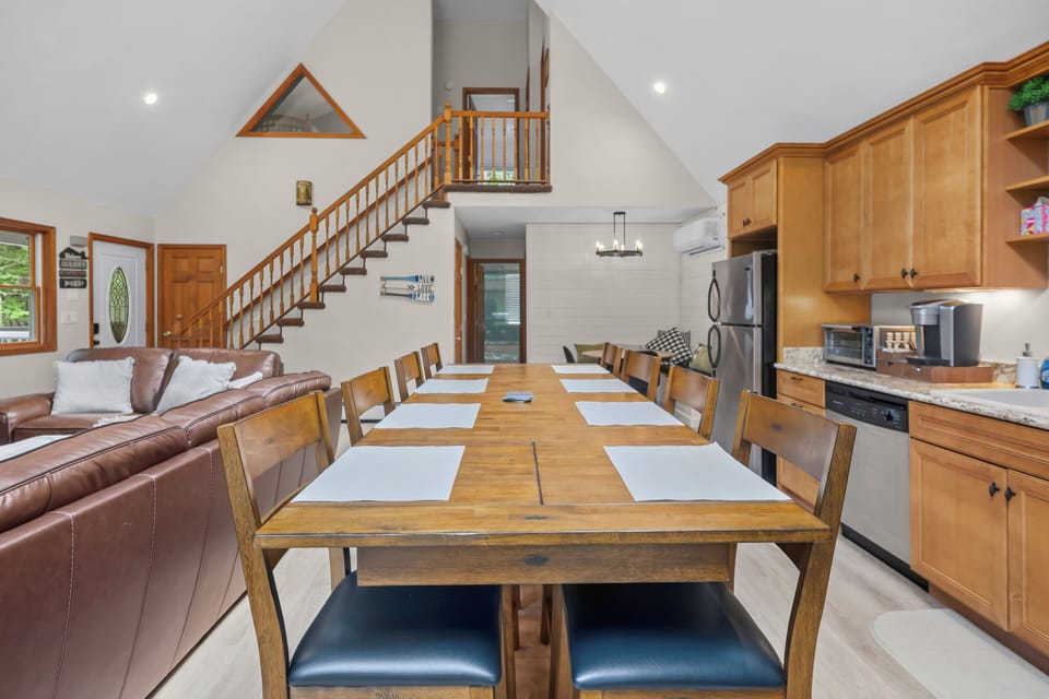 Spacious open dining area with seating for 8 and cozy loft-style charm