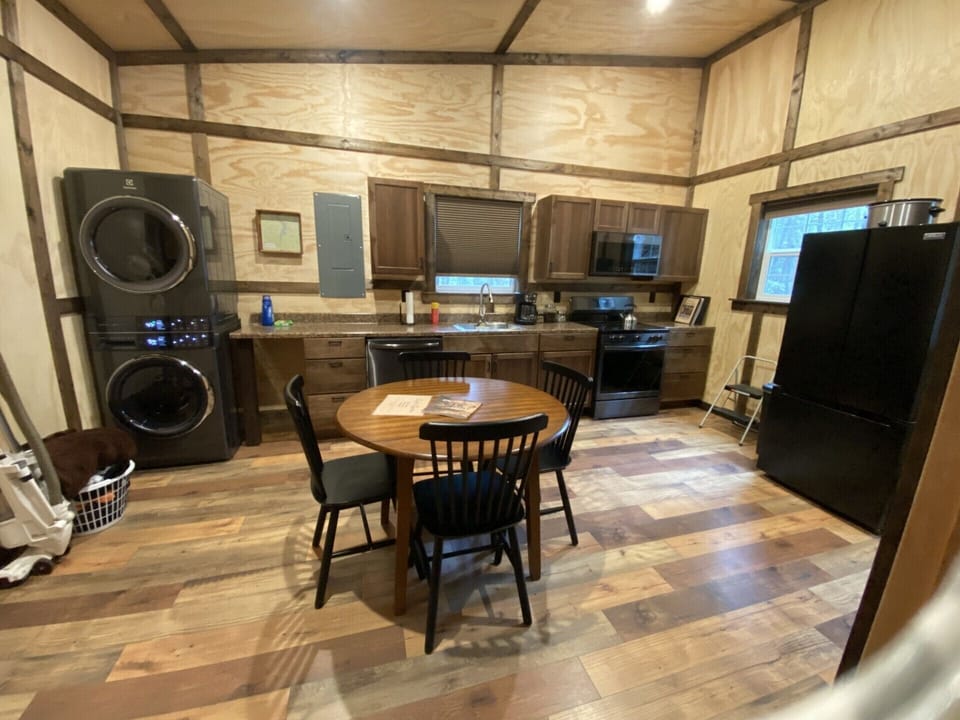 Full kitchen with all appliances, cooking utensils, and a washer and dryer.