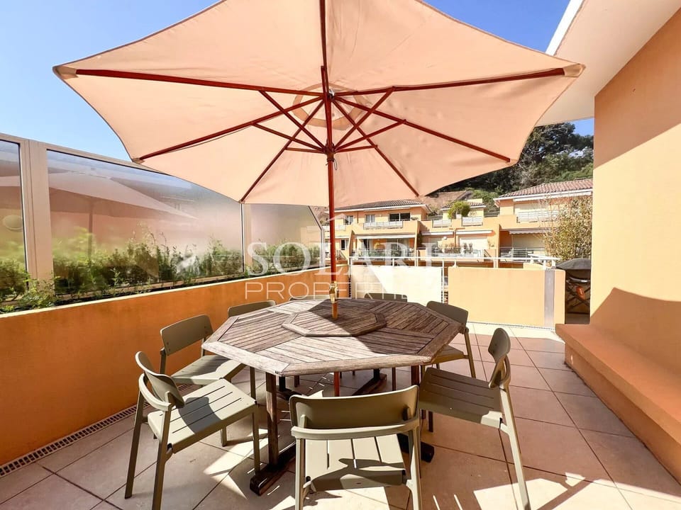 Outdoor dining area with parasols and barbecue