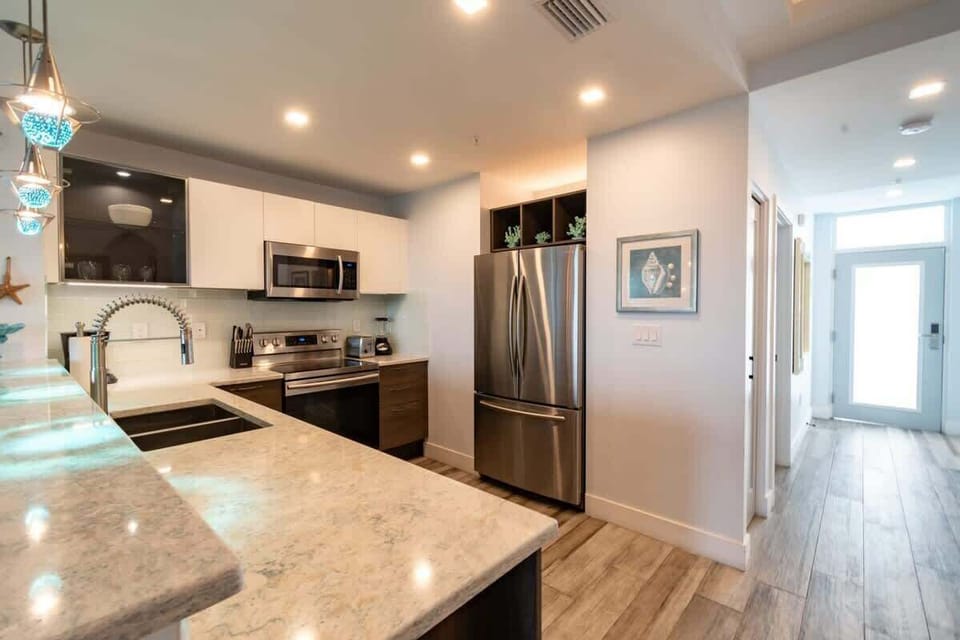 Modern kitchen with stainless steel appliances and marble countertops