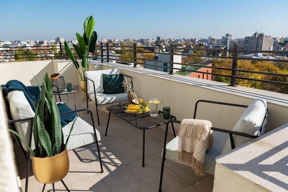 As the sun sets, our terrace becomes a stage, with the city lights dancing to the rhythm of our story.