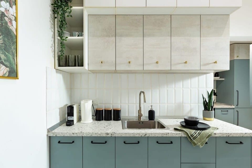 Elevate your cooking experience in our luxurious kitchen, where sleek modern design meets refreshing dry creek turquoise accents, creating a vibrant yet elegant ambiance.