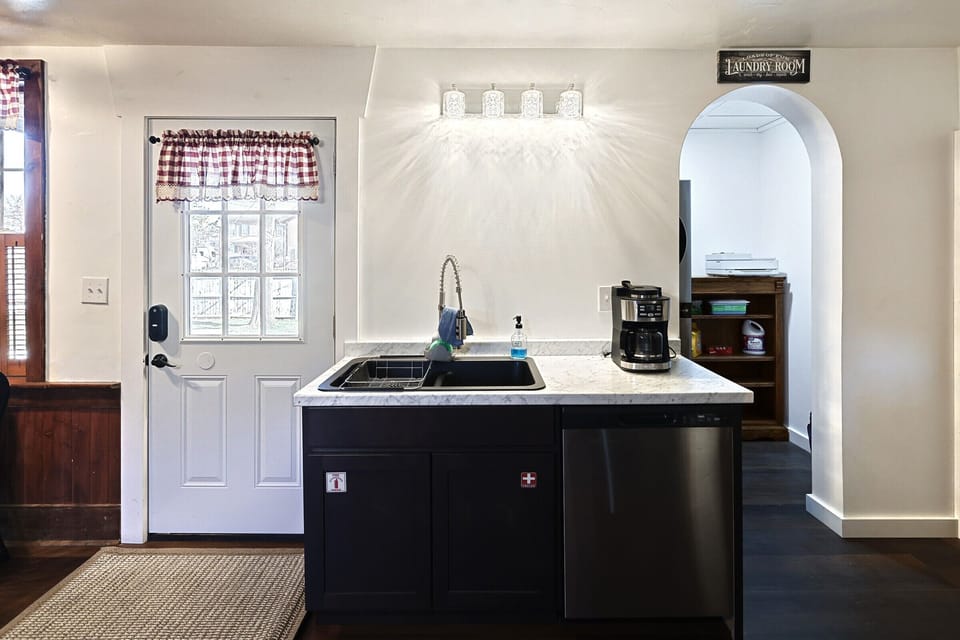 Kitchen sink, door to outside and laundry entrance