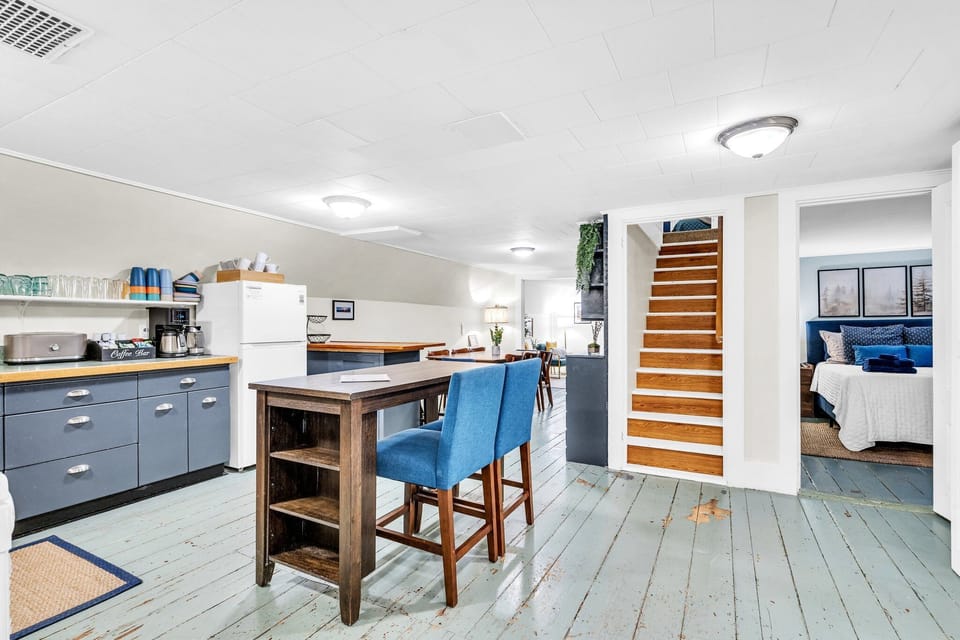 Overview of the 2nd floor, queen bedroom, and stairs leading to the 3rd floor. 