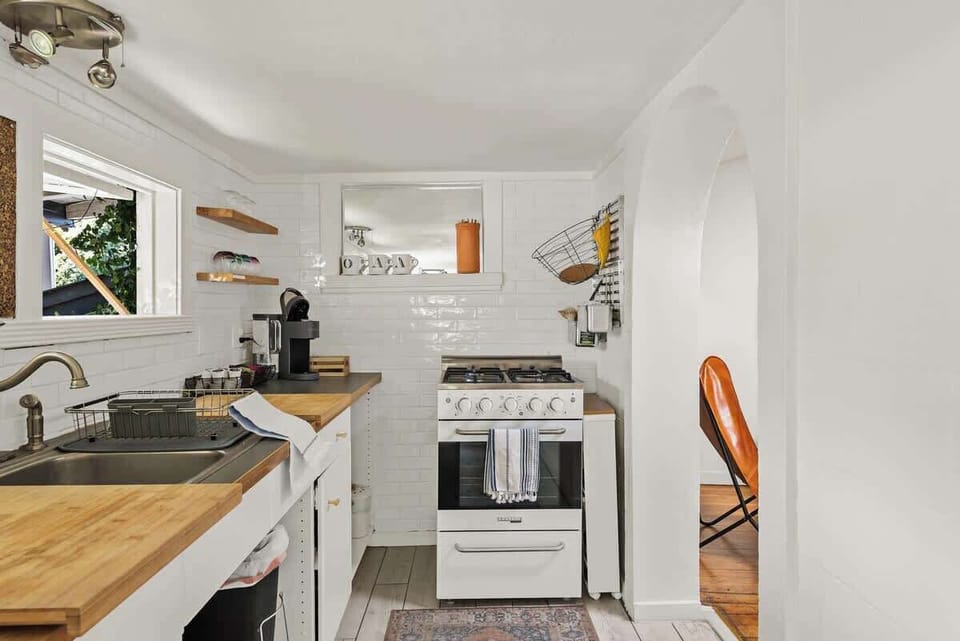 full kitchen stocked with salt + pepper, EVO, cooking spray, various other spices, coffee pods, ground coffee, and various random tea. Keurig, pour over, drip, electric tea kettle, and toaster are available.
