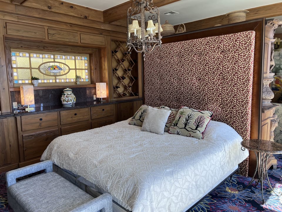 Comfy king bed looks out onto balcony and Lake Travis Sunsets