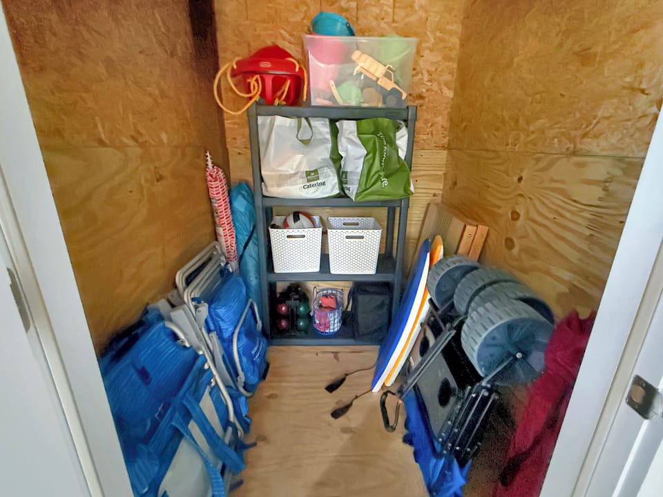 Beach-ready gear closet with chairs, wagon, boards, toys & games