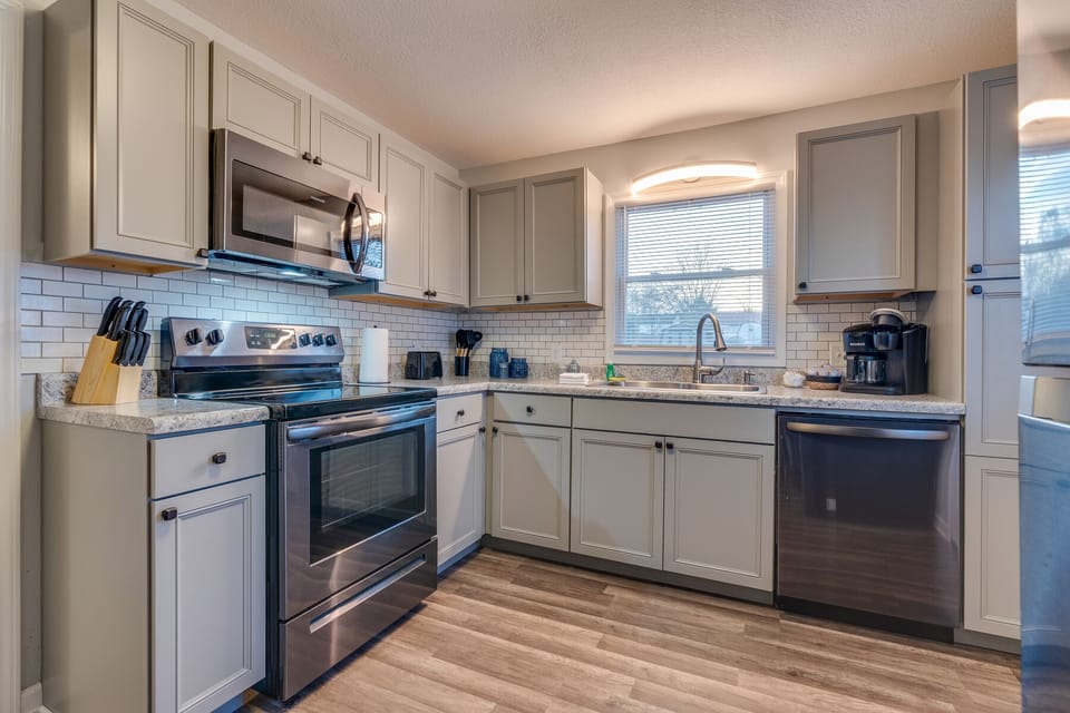The full kitchen has refrigerator, stove, microwave, and dishwasher.