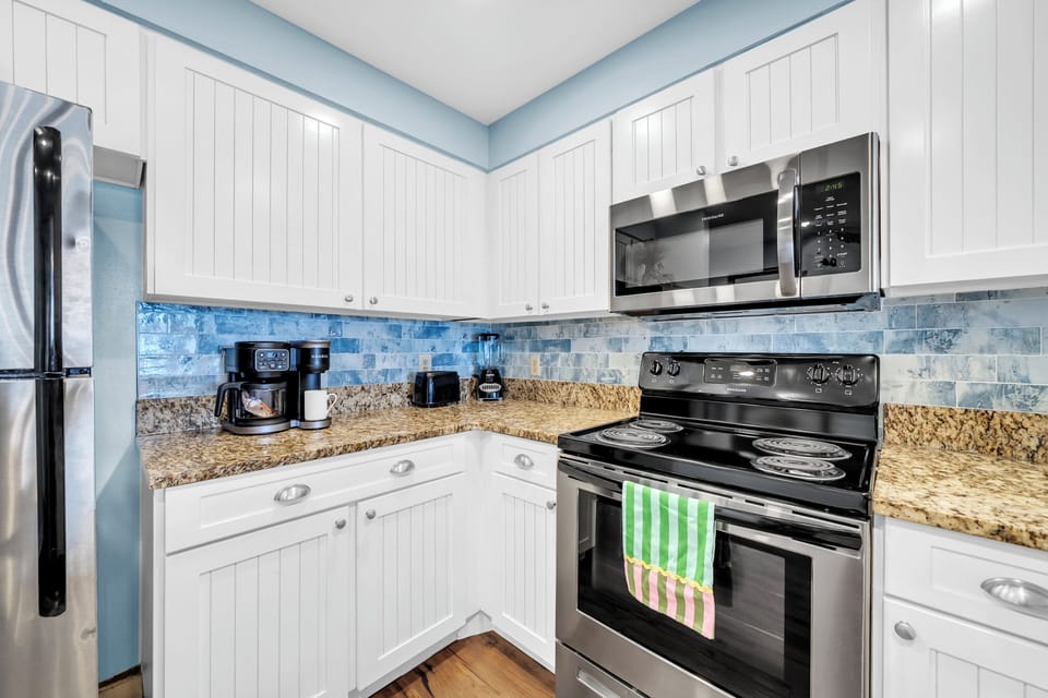 Your fully equipped kitchen features granite counters, stainless appliances, and coffee maker for creating delicious meals and morning brews together.