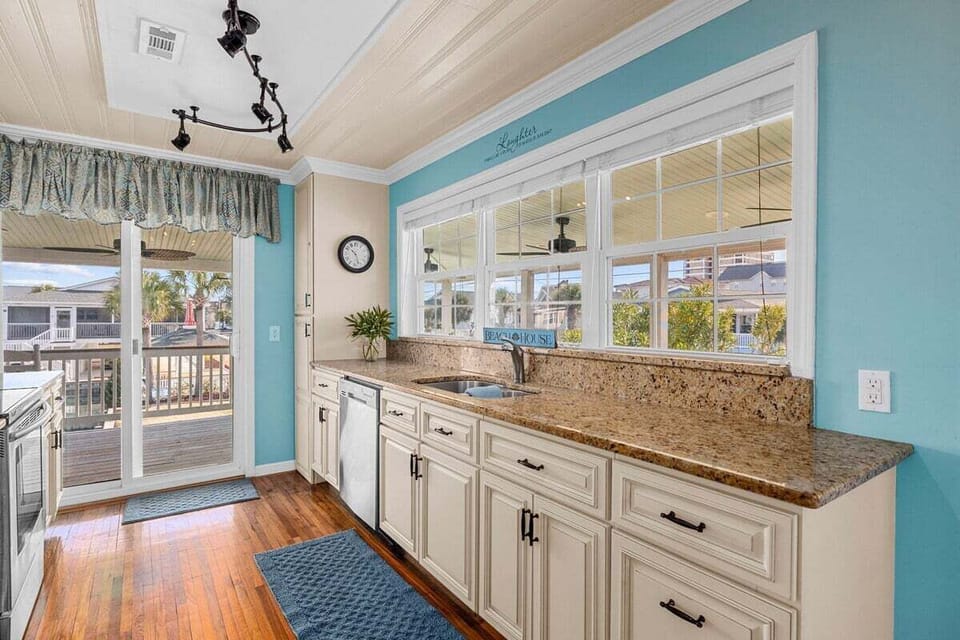 Appreciate the seamless integration of indoor and outdoor living in our kitchen, with a balcony just steps away for enjoying meals with a view
