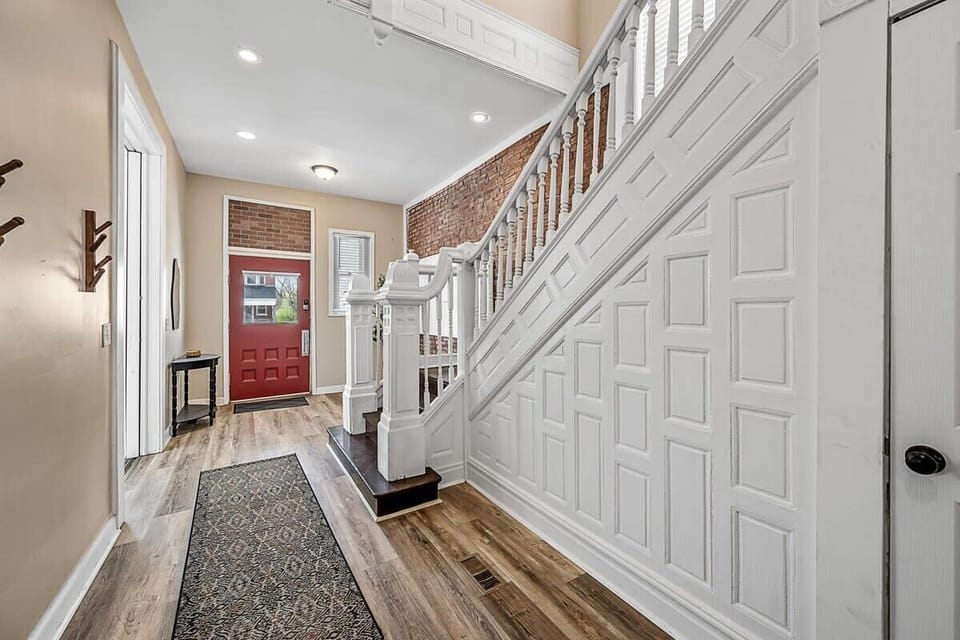 The red door beckons you to explore the enchantment beyond, while the white staircase adds a touch of elegance to this captivating hallway. #ExploreTheUnknown #CharmingEntrance #StairwayToHeaven ✨