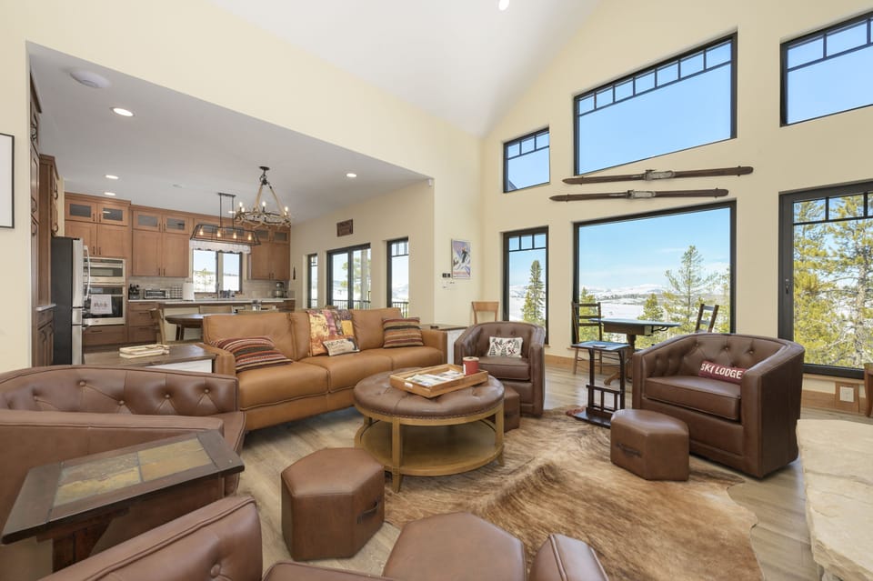 Main level living space open to dining and kitchen. Expansive views, gas fireplace, large smart TV, and Italian leather furnishings!