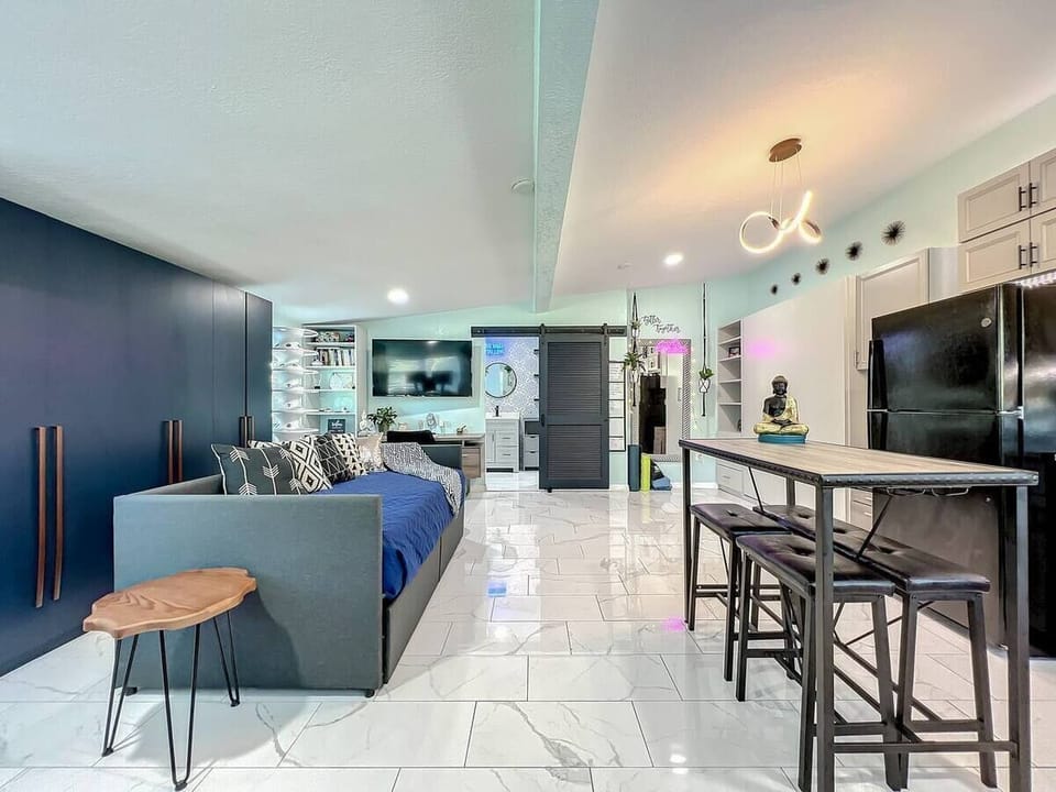This living room features a comfortable sofa and is conveniently located near the dining area and kitchen, providing an open and accessible living space.