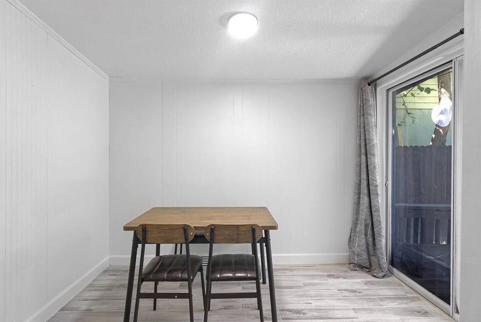 Cozy dining area with a rustic table, perfect for intimate meals by the window.