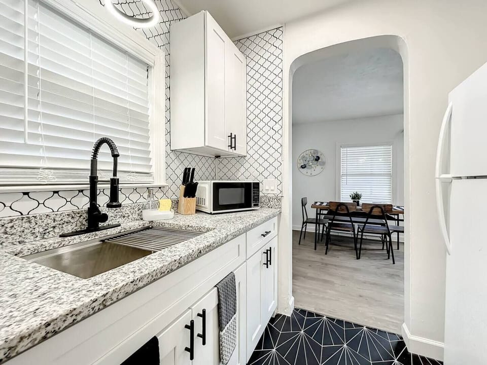 The kitchen is compact and functional, equipped with a microwave, and spacious cabinets that provide ample storage space.