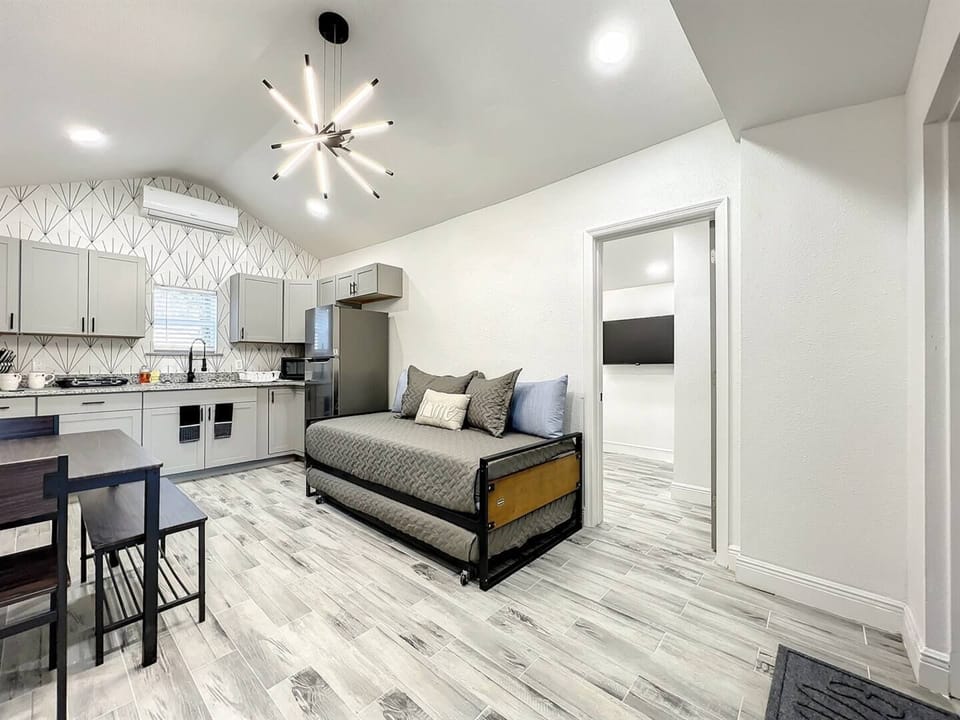 living room with trundle bed, dining room and kitchen