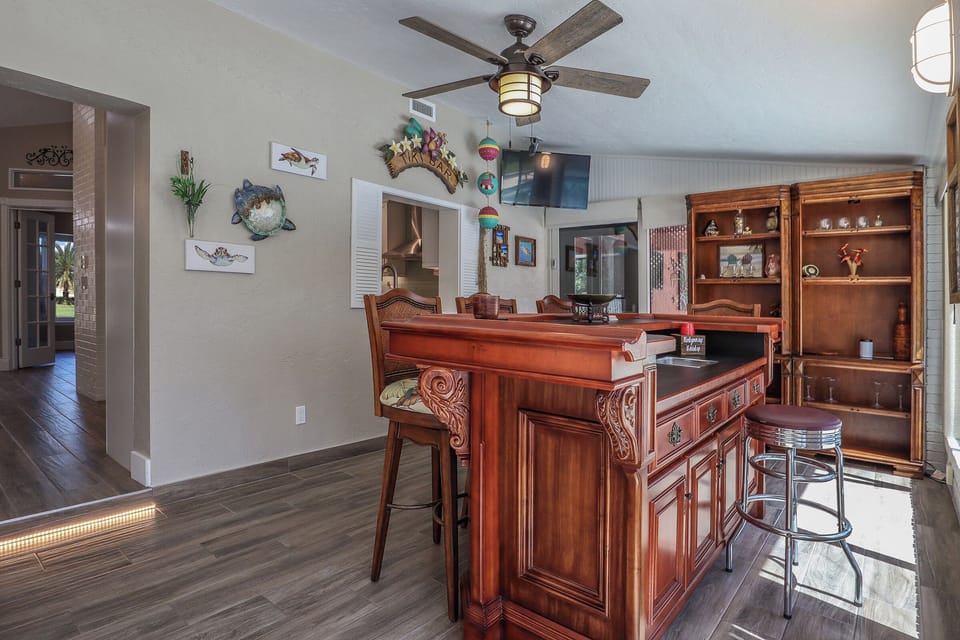 The Sun Room is an open, air-conditioned space that features an antique bar, a separate dining area and view of the pool.