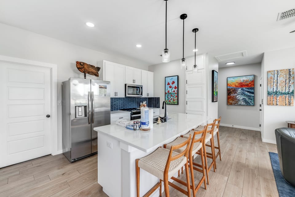 Enjoy this bright, open kitchen with a generous island — the perfect spot for easy meal prep and laid-back coastal living.