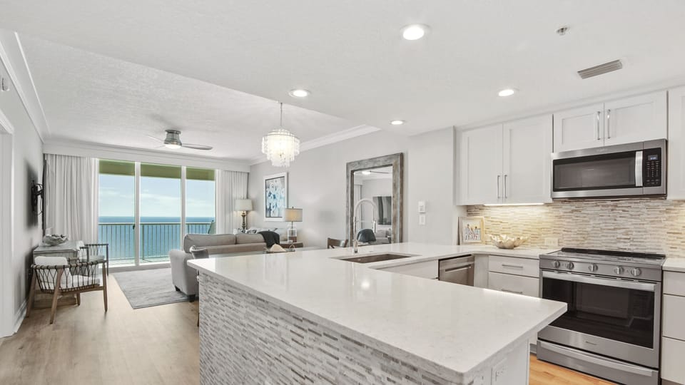 Custom kitchen with stainless steel appliances and beautiful accent tile.