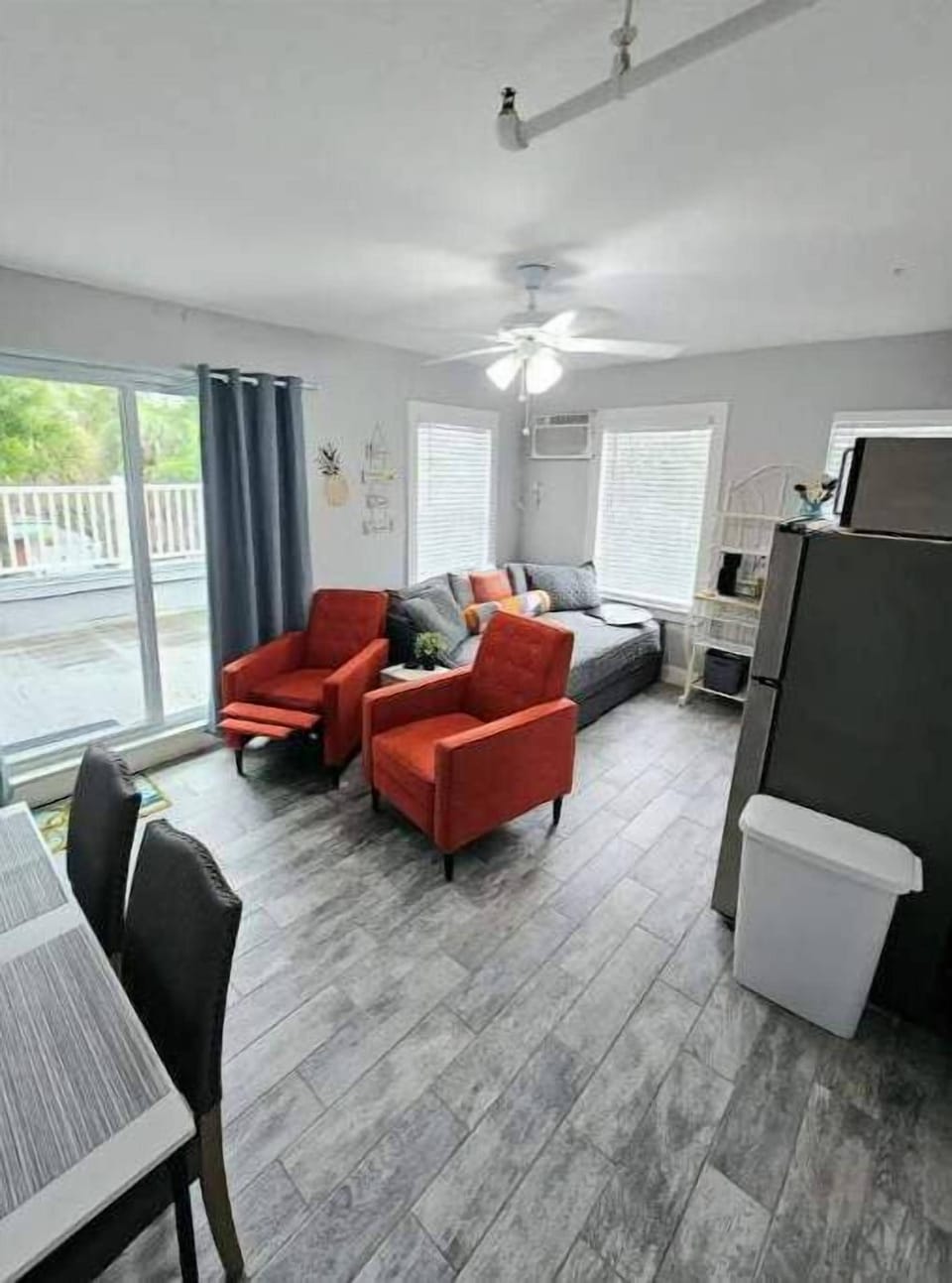 Studio with desk/eating space, 2 recliners, full size bed, kitchen, & patio.