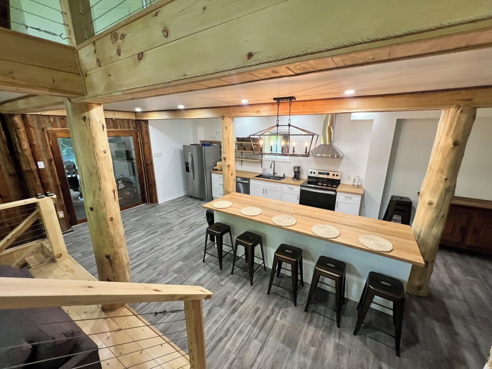View of the kitchen from the stairs. The island seats approximately 5 people