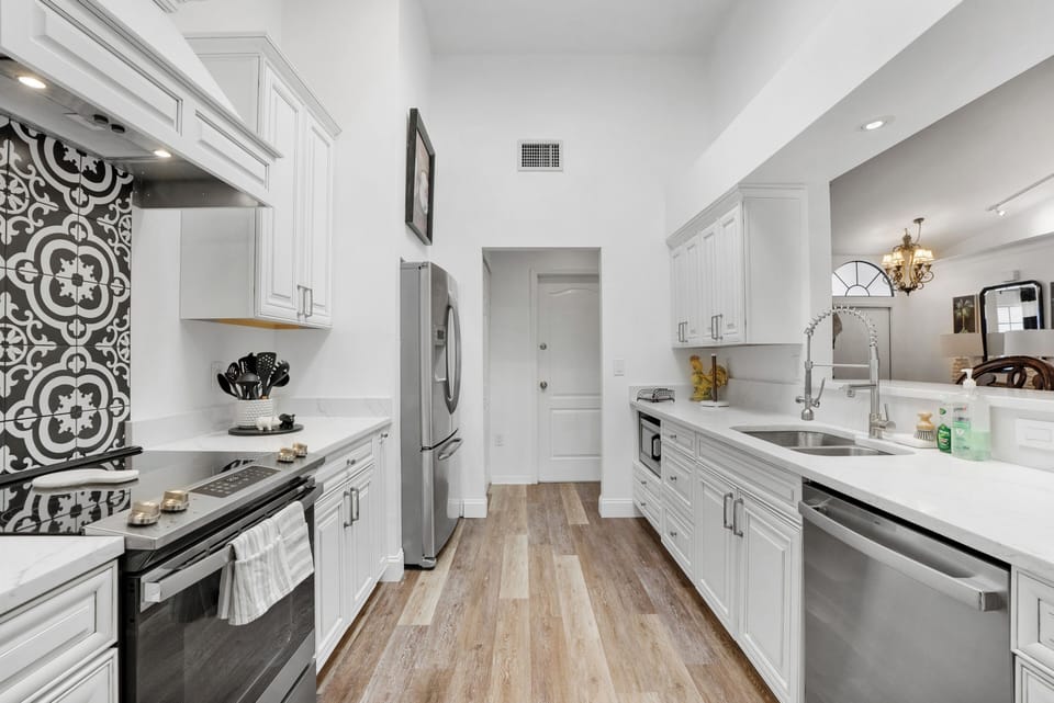 One view of the kitchen looking into large pantry area leading to laundry room