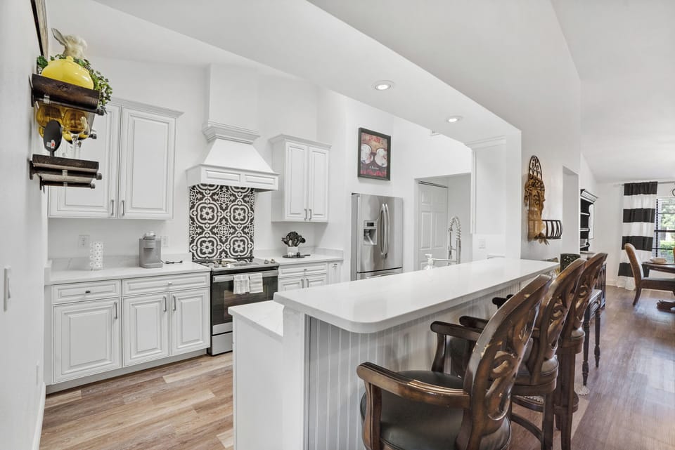 Looking into the open kitchen from the family room, large bar area.