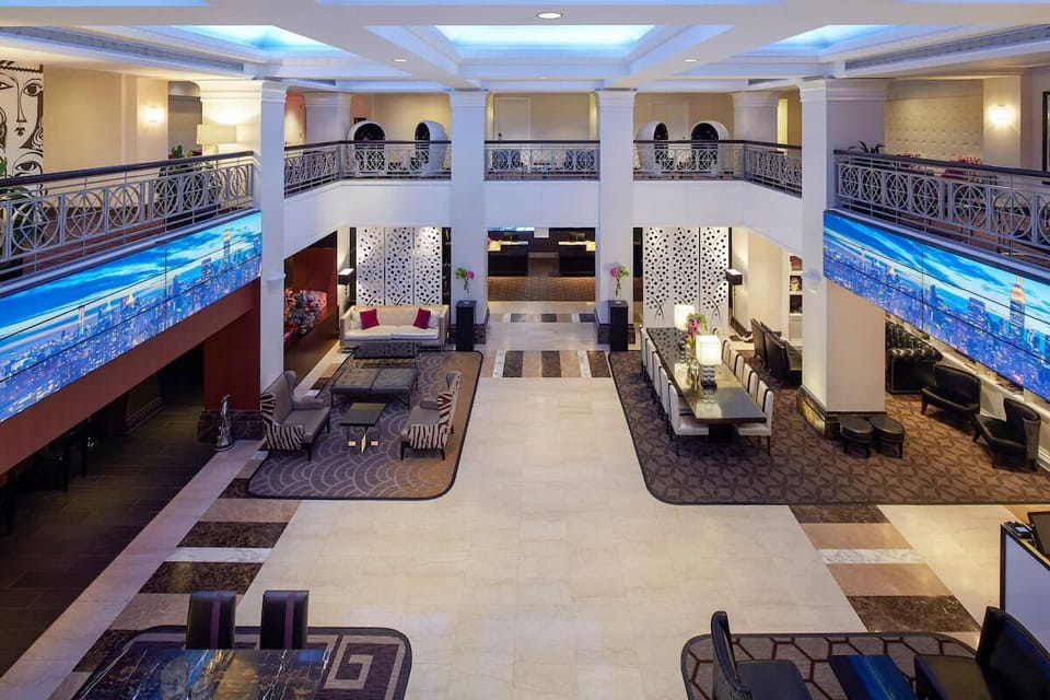 Arrive to a grand, light-filled lobby with elegant seating.