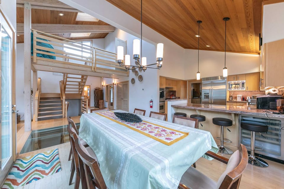 Gather with your loved ones at the spacious dining table with seating for 8. A kitchen bar with 4 barstools is comfortably situated next to the table offering extra dining space.