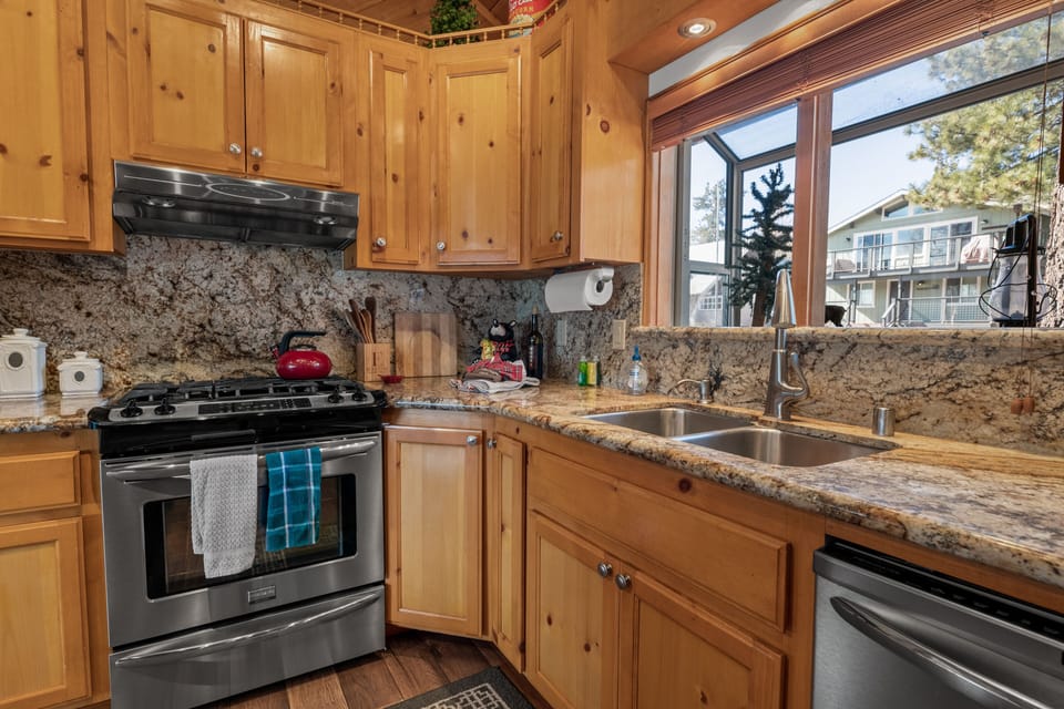 Kitchen - The kitchen is fully equipped w/granite countertops, stainless steel appliances, & a custom wood-top island w/seating.