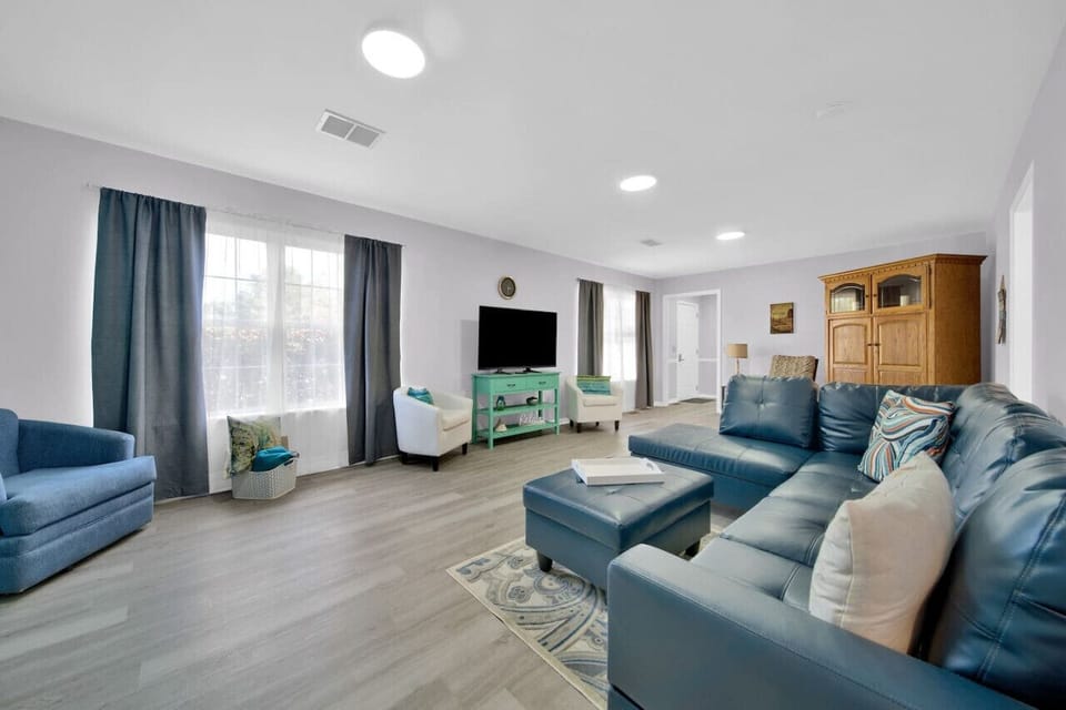 Living room with ample seating to cozy up and watch a movie when the weather doesn`t cooperate.