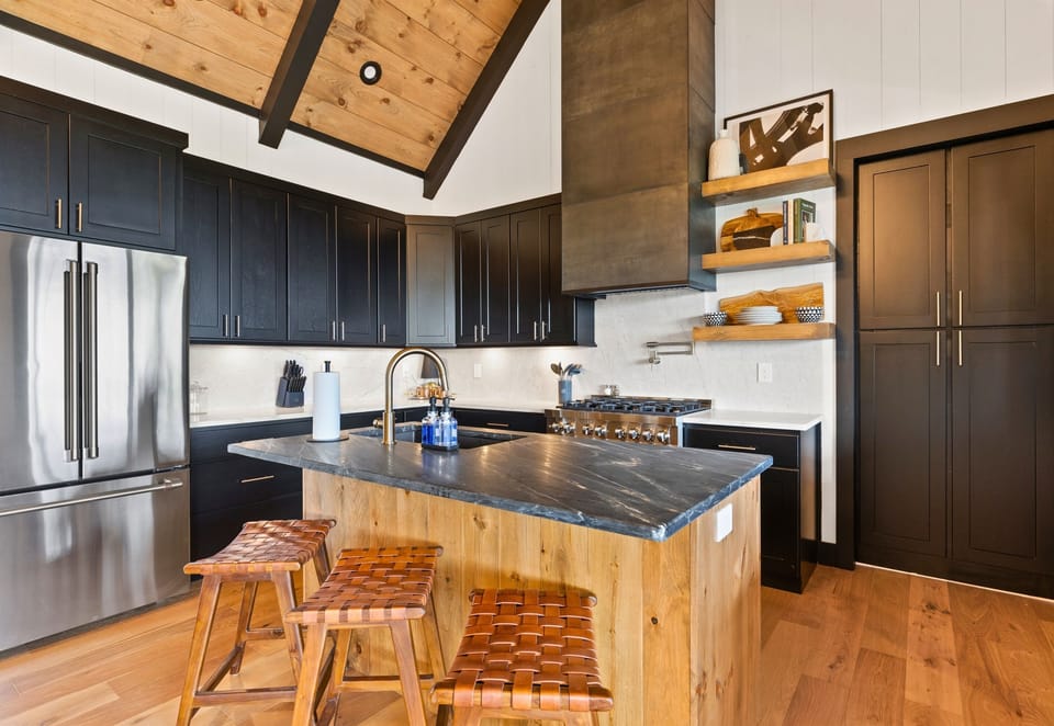 Experience culinary delight in the modern kitchen, where sleek appliances meet warm wood accents, all designed to inspire your inner chef.