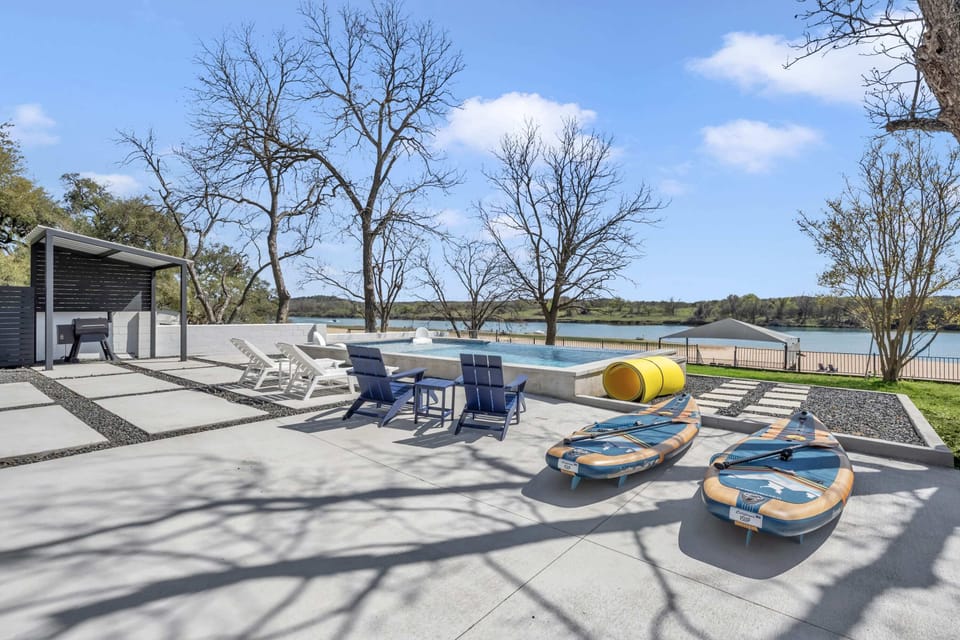 Lounging chairs, 2 stand up paddleboards, and a floating water pad