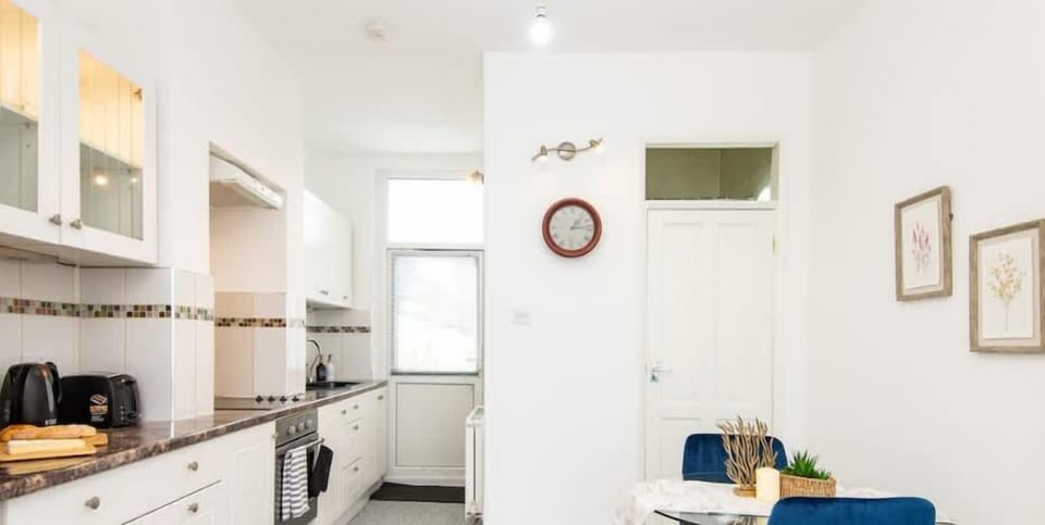 Dining table and a fully equipped kitchen.