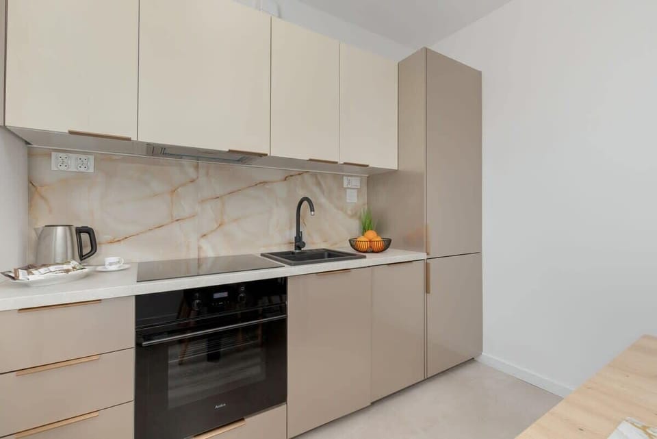 The kitchen's contemporary decor complements the apartment's style.