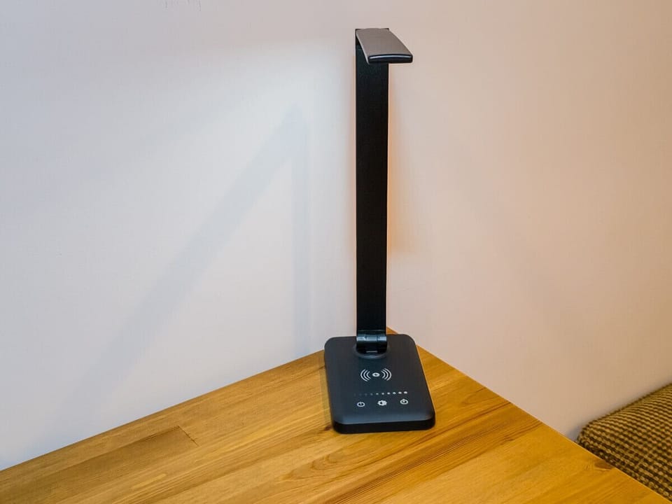 The workspace offers a smart light, fit with a charging dock for your small electronics.