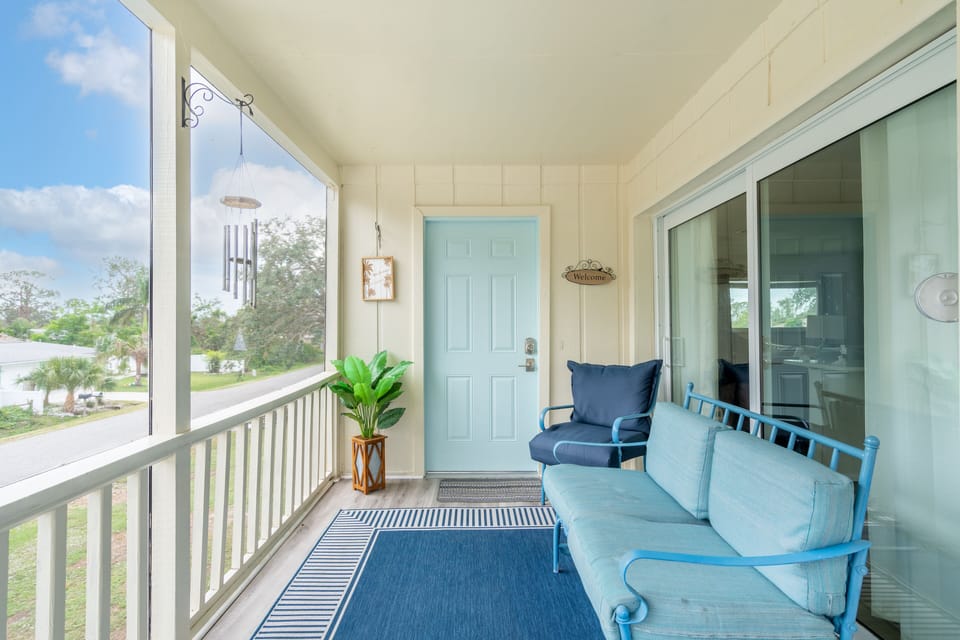 Upstairs entry porch with glider and two chairs