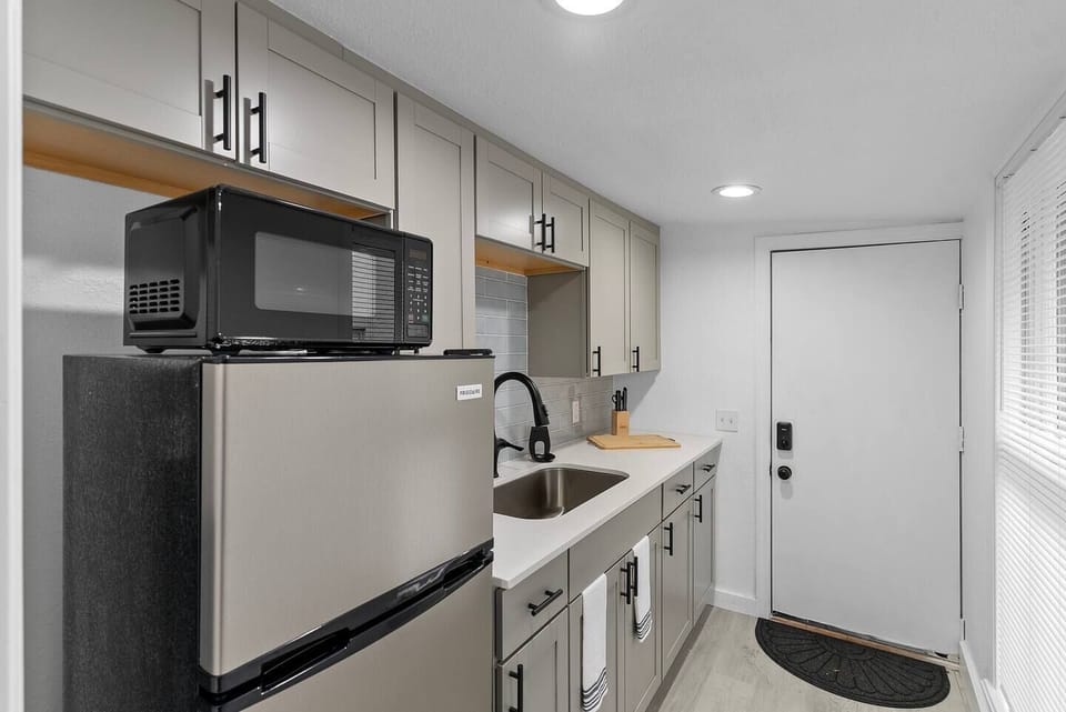This compact kitchen is designed to maximize space and functionality. With cabinets in soft tones