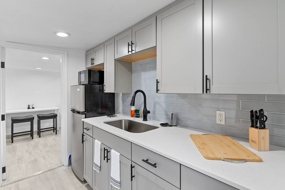 This compact kitchen is designed to maximize space and functionality. With cabinets in soft tones