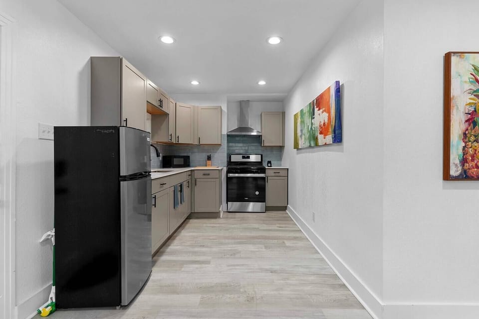 This modern kitchen is a functional space, equipped with neutral-toned cabinets that provide a clean and sophisticated atmosphere.