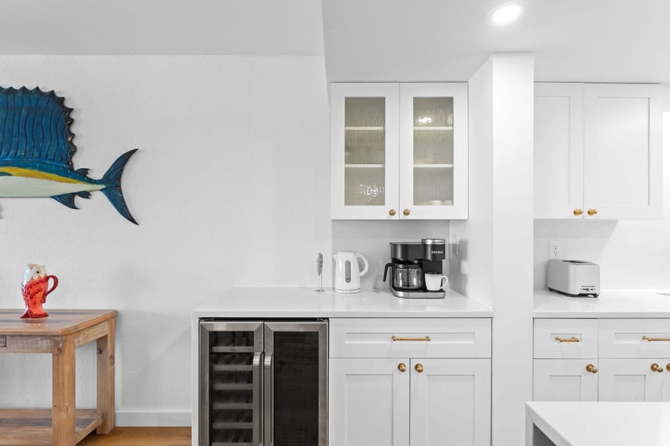 Kitchen - Beverage refrigerator and a coffee station.