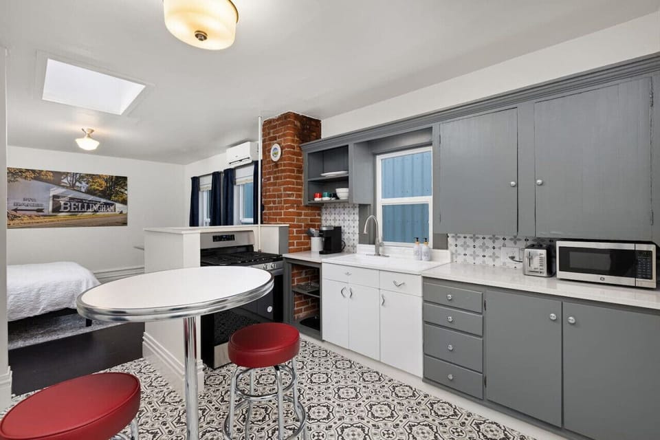 Full Kitchen With Bistro Table Seating Facing King Bed