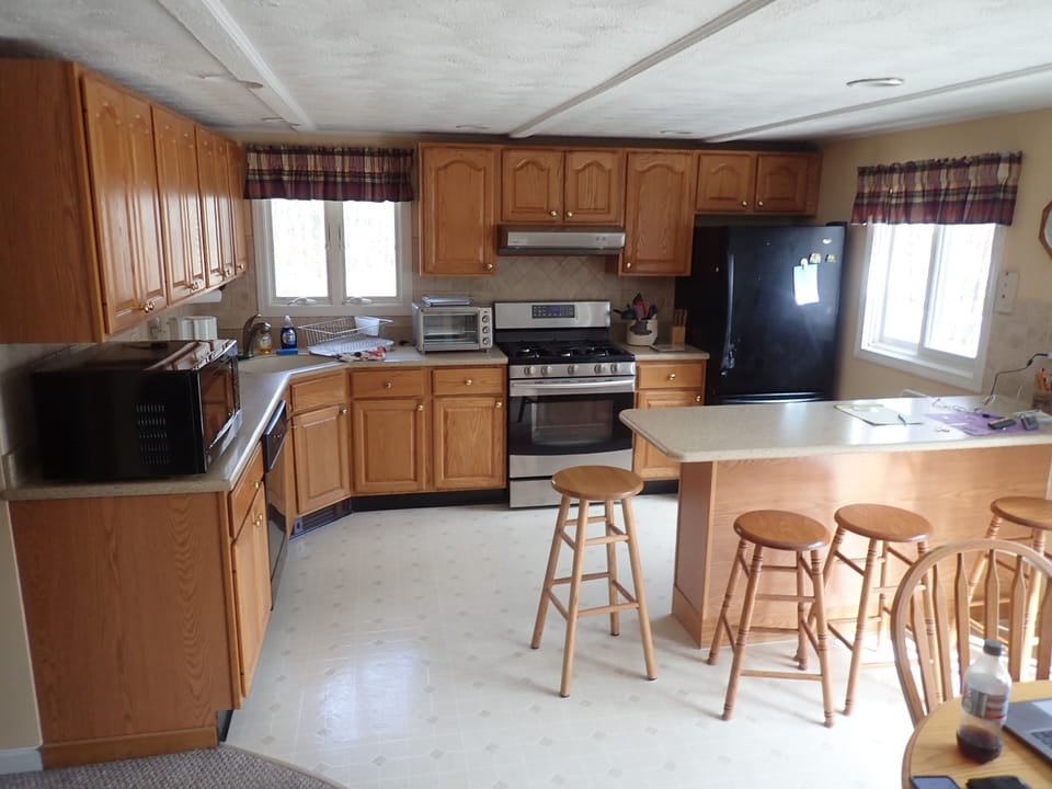Kitchen with gas range, microwave, toast oven/air fryer, refrig and dishwasher