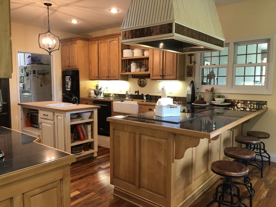 There is a glass cooktop and double ovens in the kitchen.