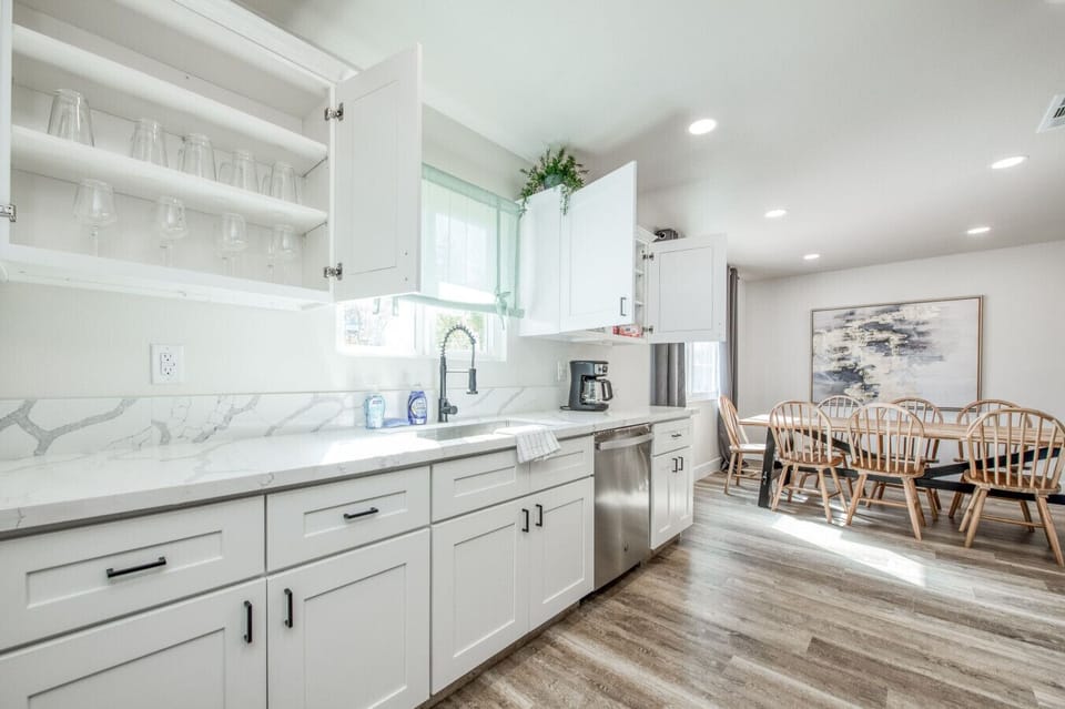 Modern kitchen with sleek counters and a cozy dining area.
